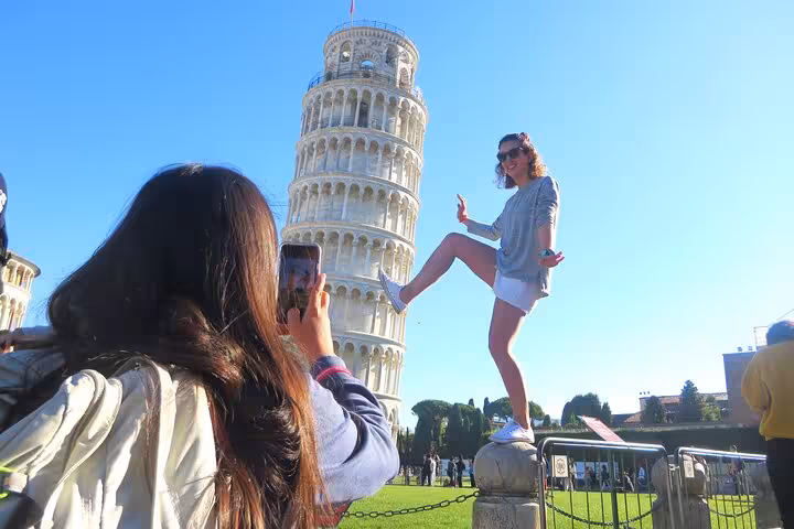 Visitor capturing a fun photo with the Leaning Tower of Pisa on a Florence to Pisa and Cinque Terre small group tour.