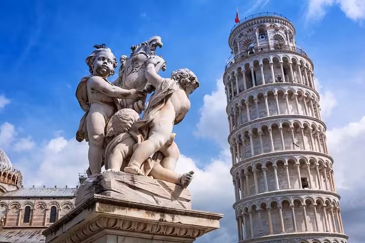 Leaning Tower of Pisa with ornate statues on a sunny day during a private tour from Florence.