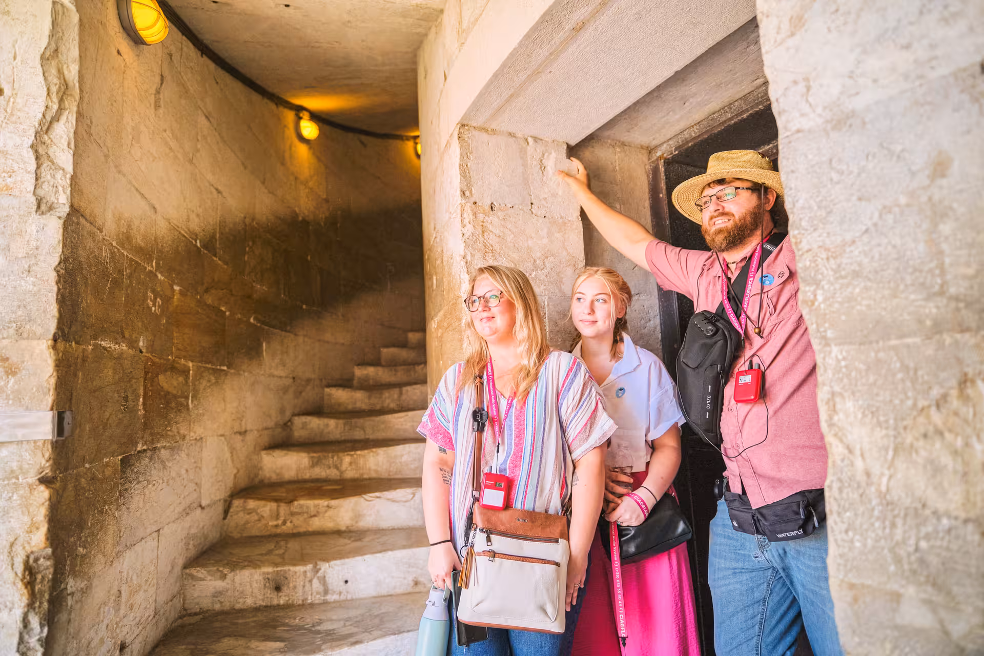 Tourists exploring the interior stairway of the Leaning Tower of Pisa during a half-day tour from Florence.