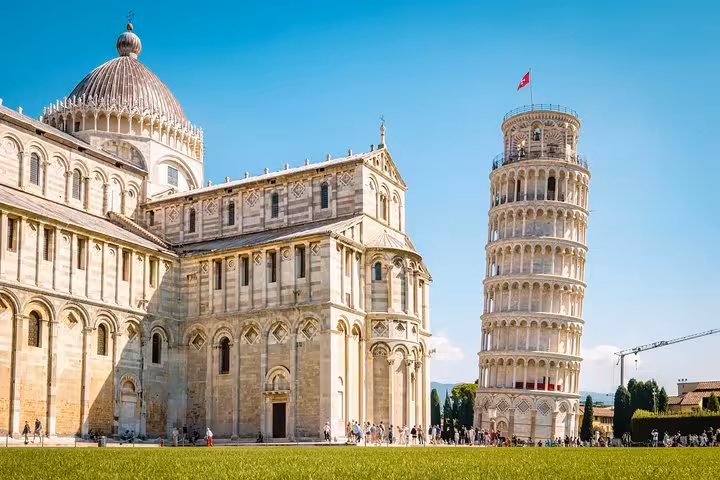 Vibrant view of the Leaning Tower of Pisa and Pisa Cathedral under a clear blue sky, ideal for Livorno shore excursions.