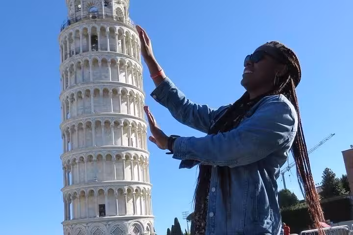 Capture a playful moment with the Leaning Tower of Pisa, a must-see on the Lucca and Pisa full-day exploration.