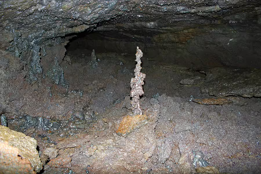 Exploring the rugged formations of Leidarendi Lava Tunnel in Iceland, showcasing natural volcanic beauty in a small group setting.