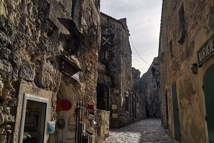 Sunlit stone alley in Les Baux-de-Provence old town, Provence village walk on culture and landscapes tour