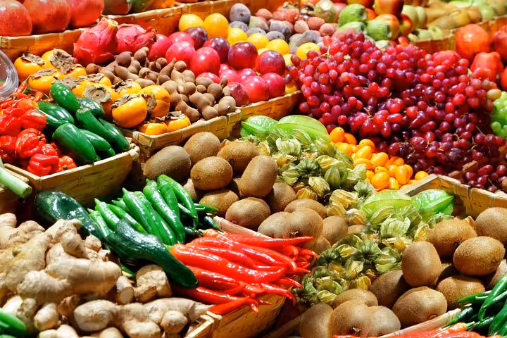Colorful array of fresh fruits and vegetables on display at Les Halles Paul Bocuse market, highlighting local produce variety.