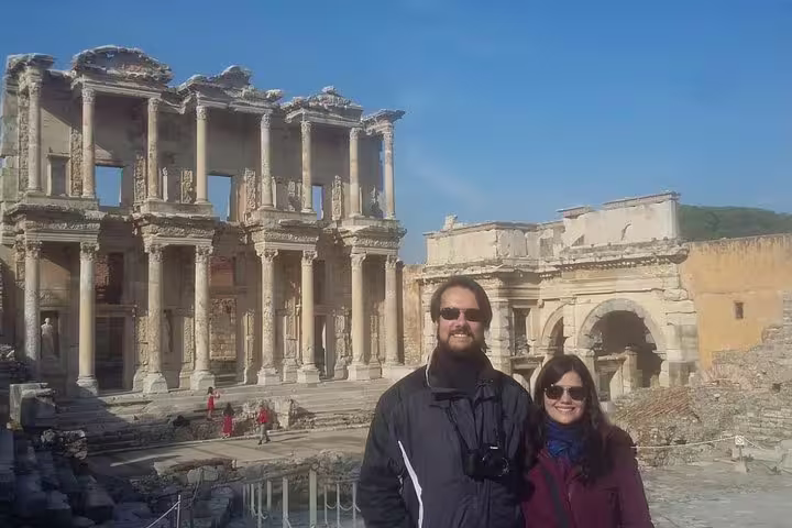 Travelers posing at the Library of Celsus in Ephesus, a popular Izmir to Ephesus day trip highlight
