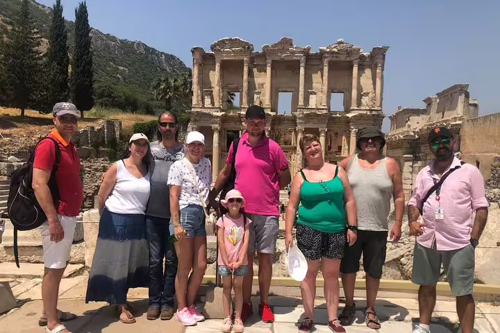 Visitors posing at the historic Library of Celsus, Ephesus, on a day tour from Kusadasi and Selcuk hotels.
