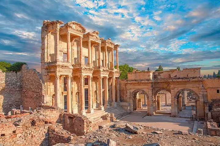 Scenic view of the Library of Celsus at Ephesus under a vibrant sky, highlighting ancient Roman architecture.