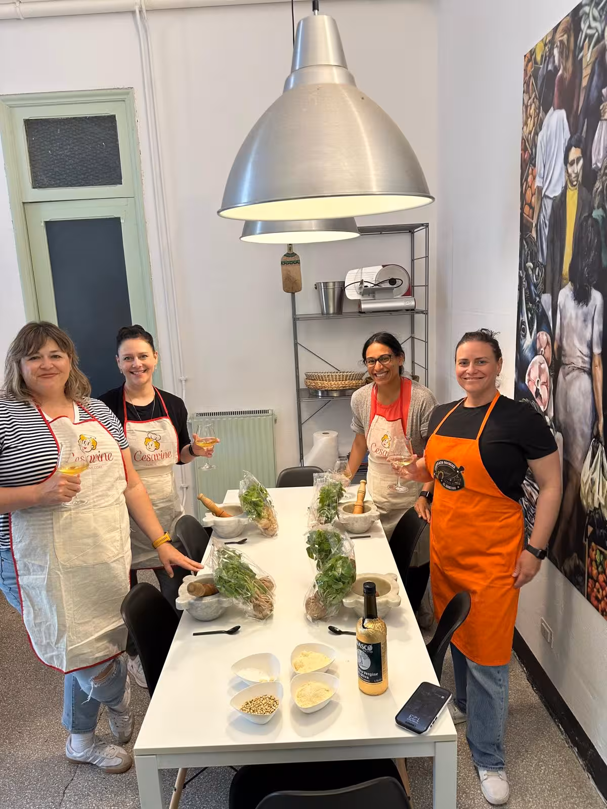 Participants in a Ligurian cooking class gather around a table, learning to make traditional Italian dishes with fresh ingredients.