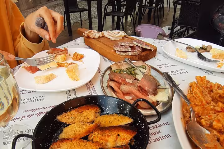 Authentic Italian lunch spread with meats and bread on the Ligurian Riviera E-bike tour.