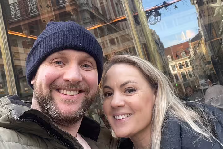 Couple selfie in Lille Old Town, exploring city highlights on a scavenger hunt walking tour near cafés