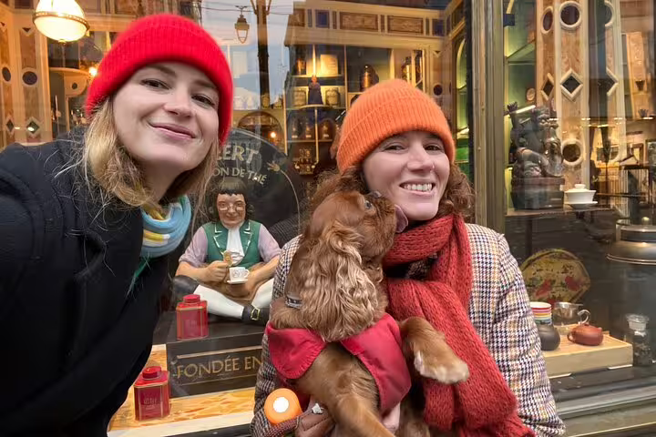 Friends with dog outside Meert tea house in Lille, a fun scavenger hunt and city highlights walking tour stop