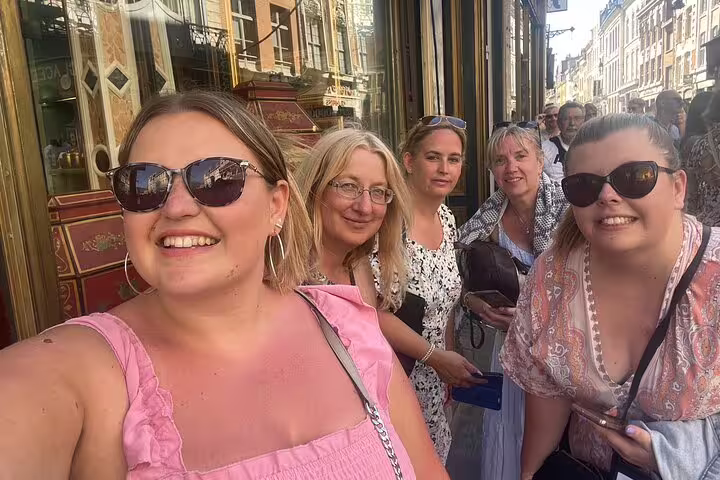Friends smiling on a Lille scavenger hunt walking tour, exploring Old Town streets and landmarks together