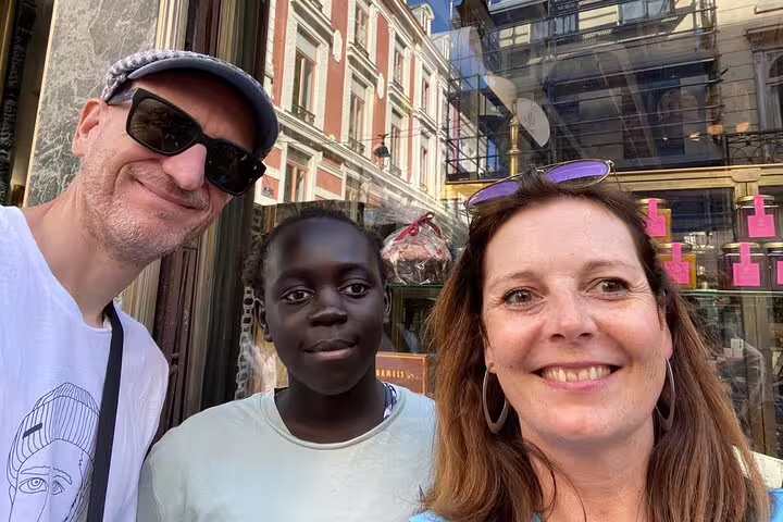 Group selfie on Lille scavenger hunt and city highlights walking tour in Lille Old Town shopping street