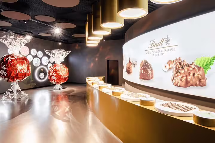 Inside the Lindt Home of Chocolate showcasing delicious chocolates and large Lindor displays for a private tour.