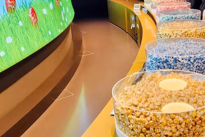 Interactive exhibits and candy bins inside Lindt Home of Chocolate Museum, Zurich experience with pick up