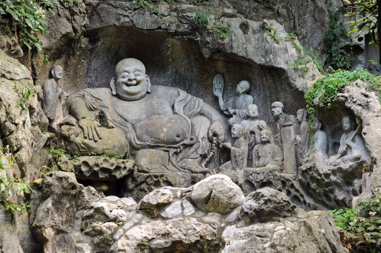 Intricately carved stone Buddha at Lingyin Temple in Hangzhou, highlighting spiritual heritage on tour.