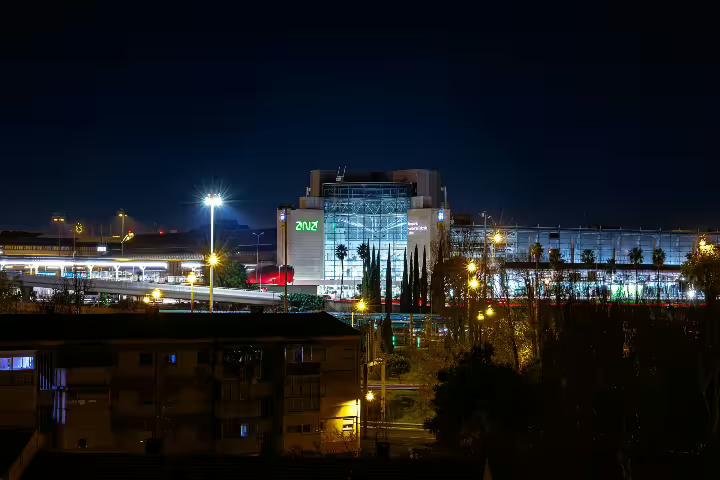 Night view of Lisbon Airport "LIS", showcasing the vibrant cityscape ideal for transfers to Ericeira, Mafra, or Torres Vedras.