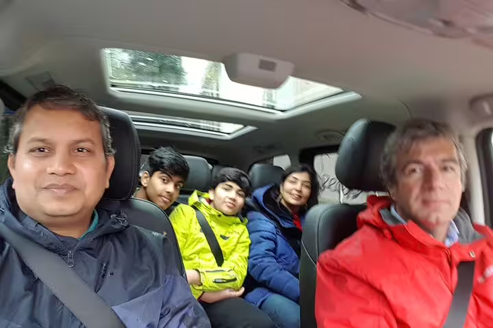 Friendly group enjoying a comfortable ride in a Lisbon airport shuttle service, perfect for smooth and hassle-free transfers.