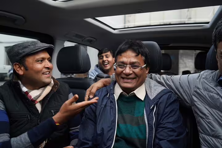 Happy group enjoying a comfortable ride in a Lisbon airport shuttle, showcasing friendly service and spacious seating.