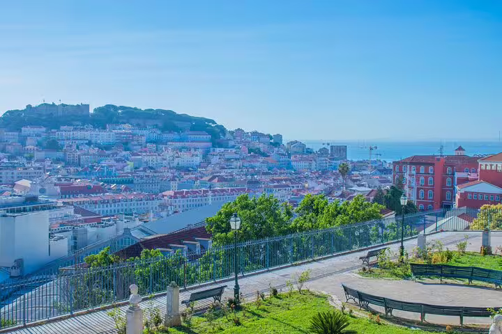 Scenic view of Lisbon's historic Alfama district from a hilltop park, perfect for exploring on a private TukTuk tour.