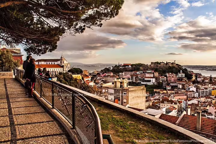 Scenic view of Lisbon's historic Alfama district at sunset, perfect for a private Fado night tour experience.