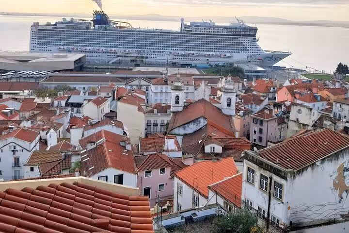 Experience panoramic views of Lisbon's Alfama district with a cruise ship docked in the background.