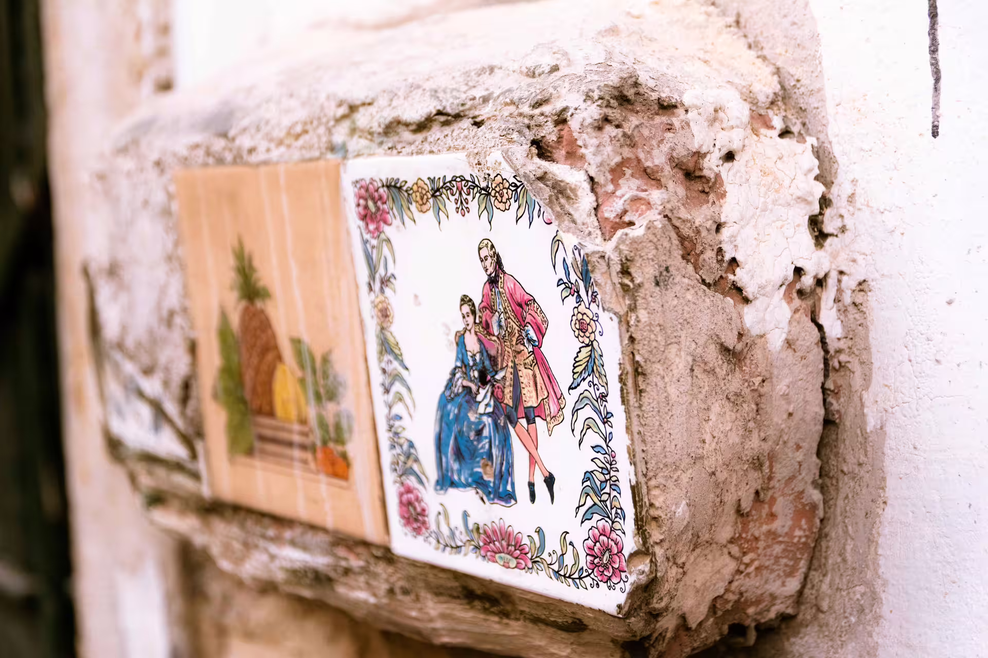 Colorful traditional Portuguese tiles on a rustic wall in Alfama, Lisbon, captured during a guided photography tour.