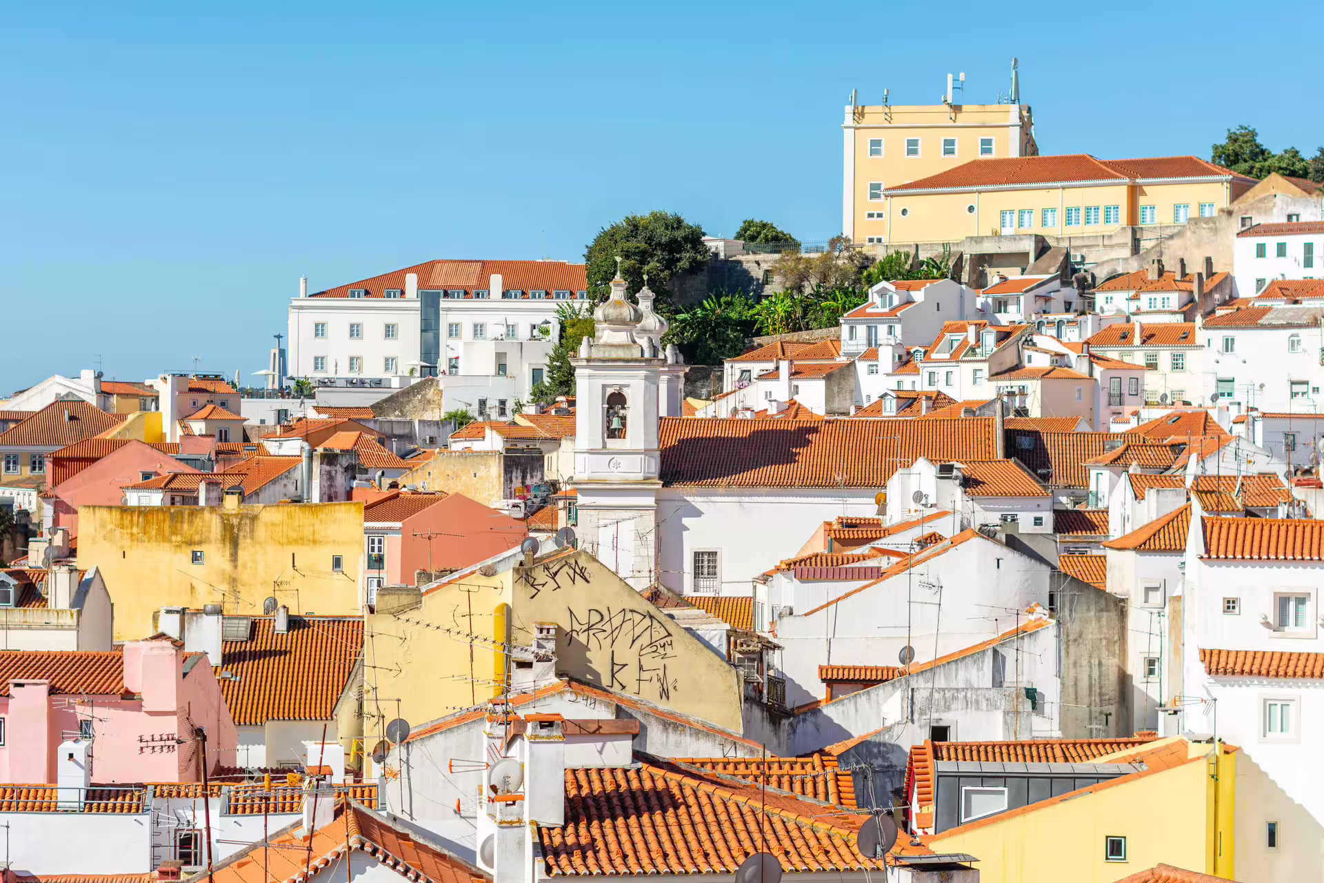 A scenic view of Alfama's charming rooftops and historic architecture, captured during a Lisbon photography tour led by a local expert.