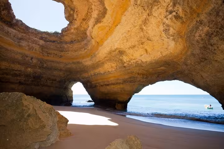 Explore the stunning Benagil Cave with azure waters on a Lisbon to Algarve private Mercedes transfer.