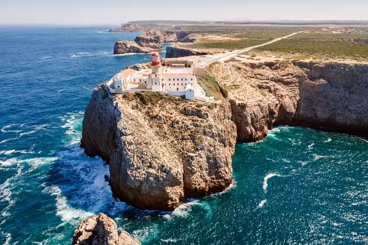Discover the dramatic Cape St. Vincent lighthouse perched on cliffs on a Lisbon to Algarve private transfer.