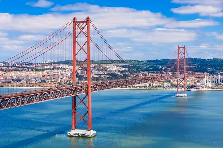 Iconic 25 de Abril Bridge spanning the Tagus River in Lisbon, a scenic view on the route to Algarve.