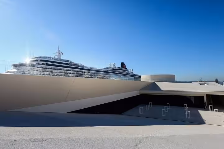 Modern cruise ship docked at Lisbon terminal, ideal starting point for a private Mercedes transfer to Algarve.