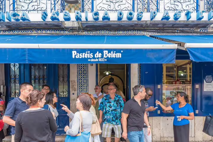 People gather outside the iconic Pastéis de Belém bakery in Lisbon, a highlight on the private bike tour of Lisbon and Belem.