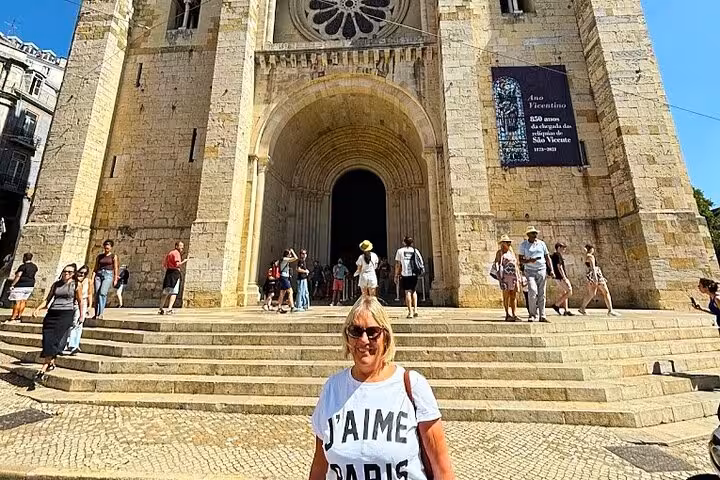 Tourist at Lisbon Cathedral Sé steps during a private tuk tuk tour of Lisbon’s historic center and landmarks
