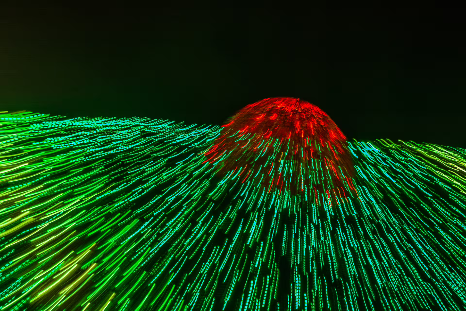 Vibrant green and red Christmas lights create a dazzling display in Lisbon's night sky during a festive private photo walk.