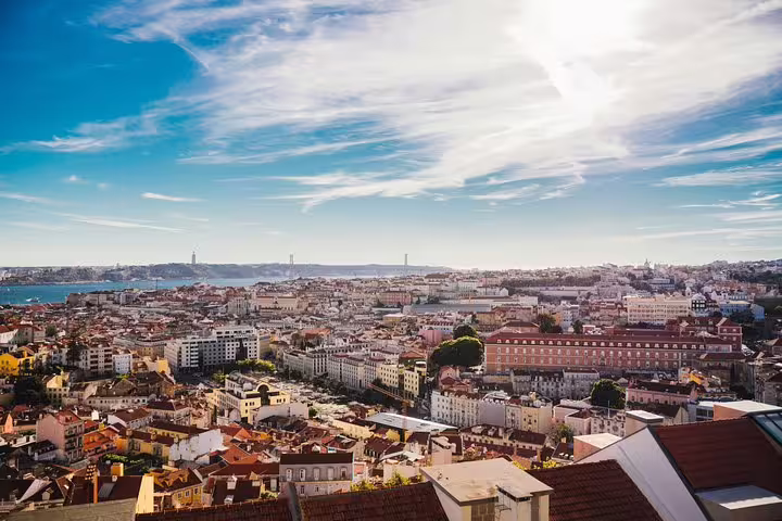 Panoramic view of Lisbon's vibrant cityscape under a bright blue sky, perfect for a private tuk tuk tour.