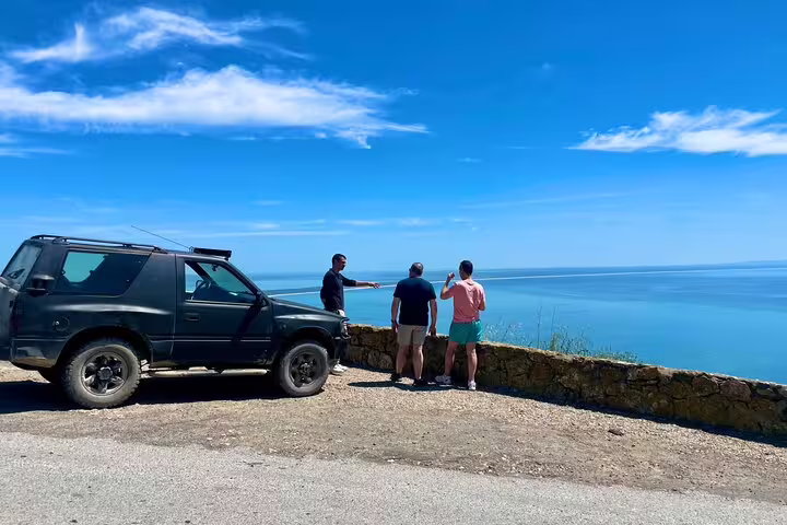 Tourists enjoy stunning ocean views during a private 4X4 Jeep and beach picnic tour in Arrábida, Sesimbra-Lisbon.