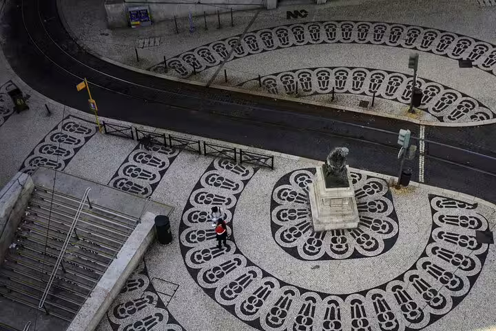 Aerial view of Lisbon's iconic patterned cobblestone square featuring a statue, ideal for a full-day private tour and gastro experience.