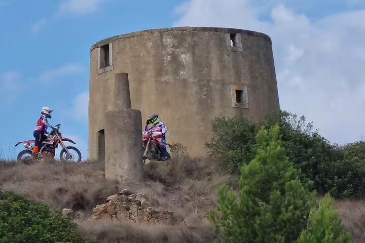 Two riders explore historic ruins on a thrilling Lisbon enduro tour adventure.