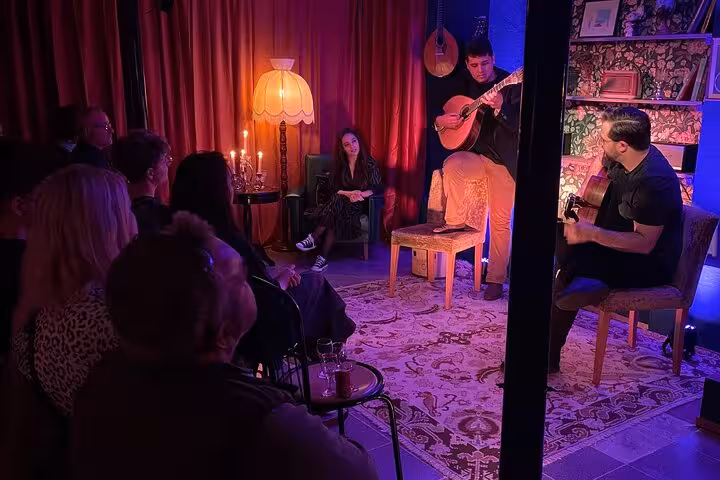 Intimate Lisbon Fado concert with guitarists captivating an audience in a cozy, candlelit setting.