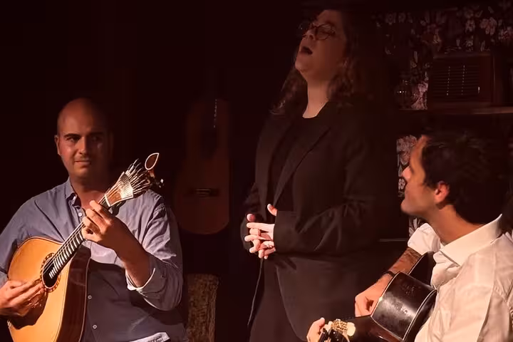 Passionate Fado performance in Lisbon with singer and guitarists, offering an intimate cultural music experience.
