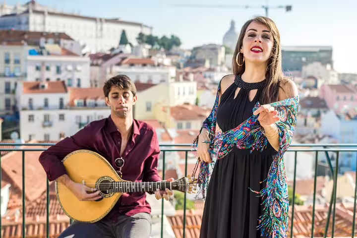 Musicians performing traditional Fado with Lisbon's scenic rooftops in the background during a private city highlights tour.