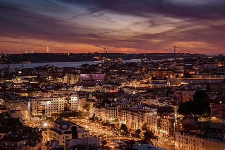 Lisbon's enchanting skyline at dusk sets the stage for a captivating private Fado night tour, showcasing the city's vibrant culture.
