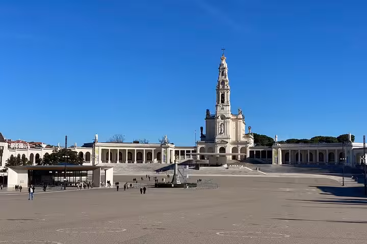 Majestic Fatima Basilica under clear blue skies, a highlight on the Lisbon to Fatima guided tour for 8 pax.