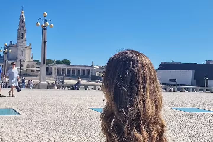 Tourist admiring the Basilica of Our Lady of the Rosary in Fatima, a highlight of the private tour from Lisbon to Portugal's largest caves.