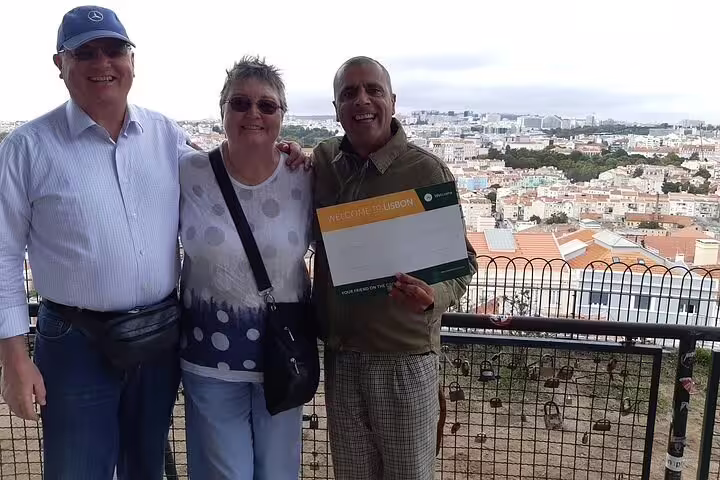 Travelers with local guide at Lisbon viewpoint before private tour to Fatima Sanctuary, Batalha and Alcobaca