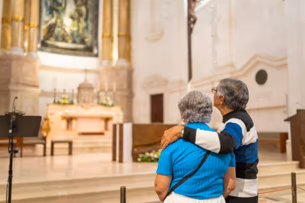 Couple admiring the serene interior of a church in Fátima during a Lisbon small group tour.
