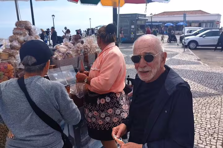 Tourists explore a local market in Nazare during the Private Full-day Fatima Nazare Obidos Tour from Lisbon.