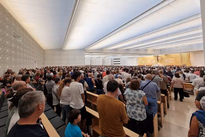 Pilgrims attending Mass inside Fatima Sanctuary basilica during Lisbon to Fatima day trip for WYD 2023