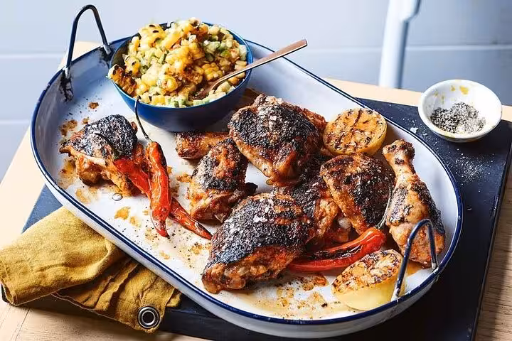 Grilled chicken and roasted peppers on a platter, highlighted on the Ultimate Lisbon Food Tour's culinary experience.